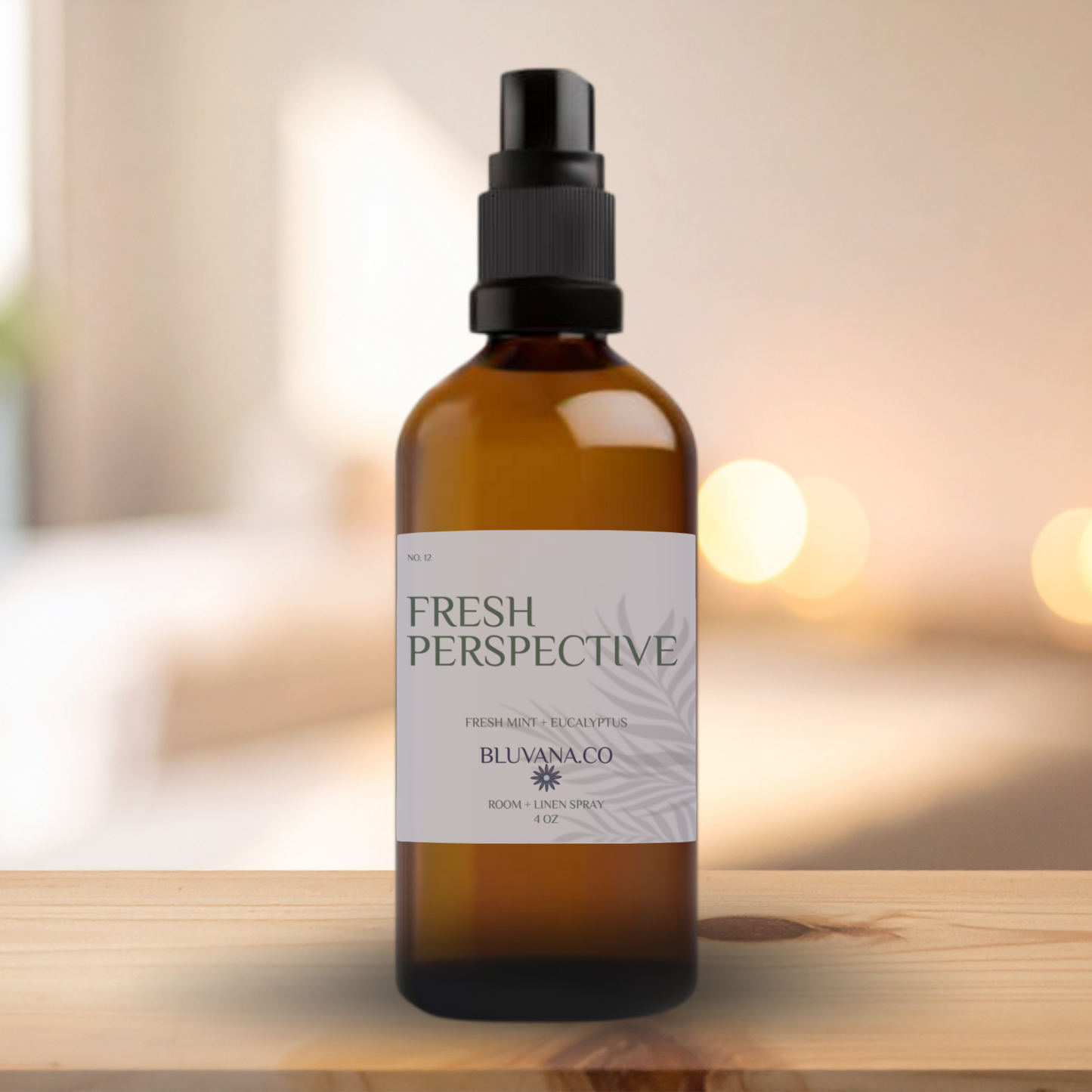 Brown spray bottle labeled 'Fresh Perspective' on a wooden surface with a blurred background
