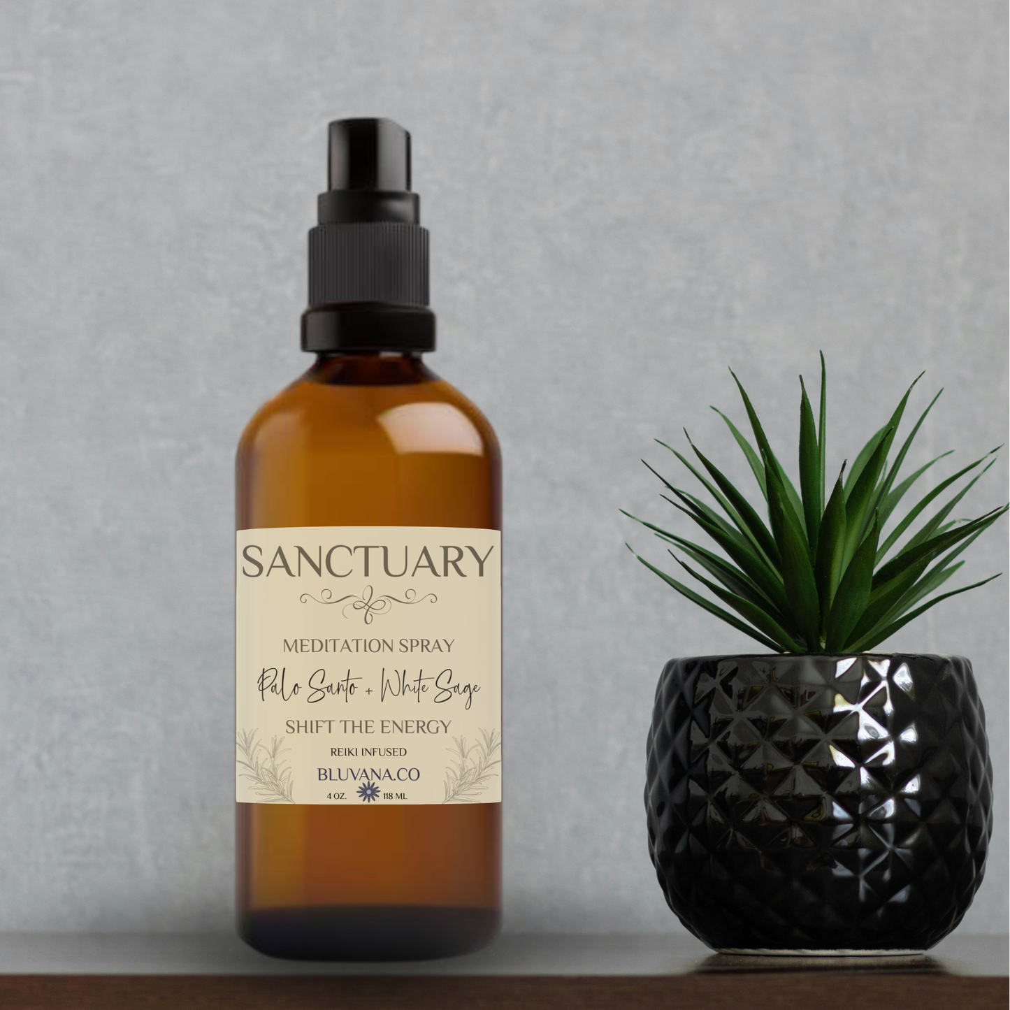 Sanctuary meditation spray bottle with a plant on a gray background