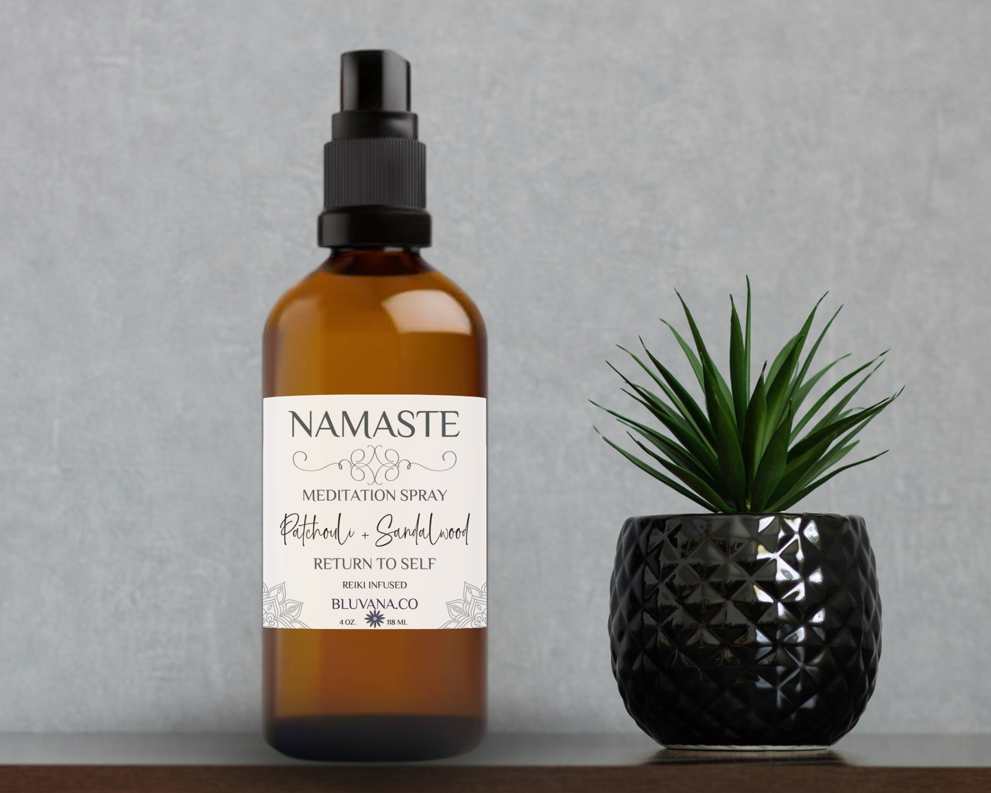 Namaste meditation spray bottle with a plant on a gray background