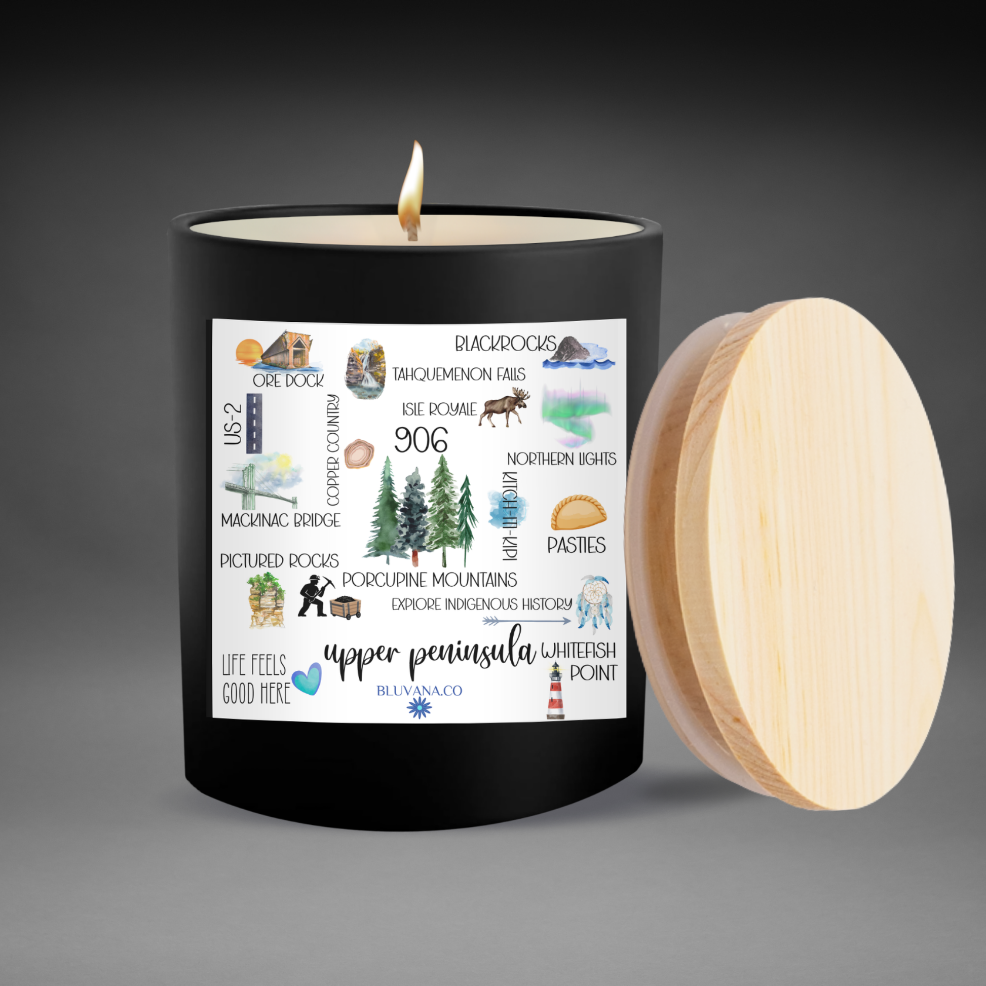 Candle with a wooden lid and label of popular places in the upper peninsula  on a gray background