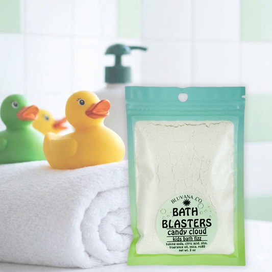 Image of a package of kids bath fizz sitting on the edge of a bathtub with a towel and rubber ducky. 