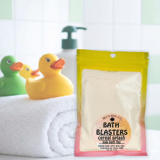 Image of a colorful bath fizz package sitting on edge of a bathtub with a yellow rubber duck next to it. 