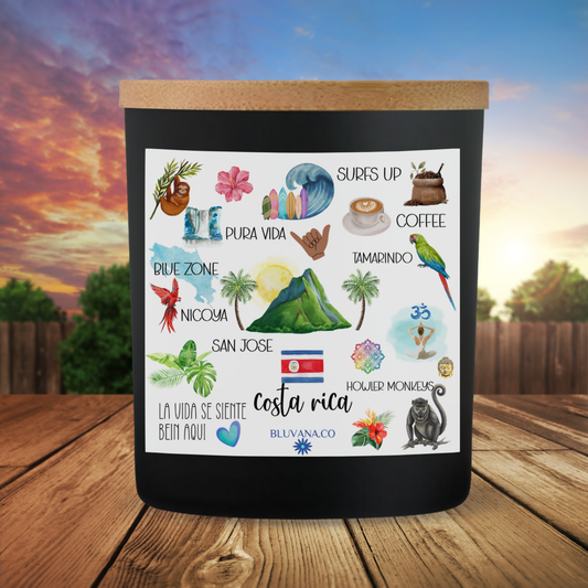 Black mug with Costa Rica-themed illustrations on a wooden surface with a scenic background