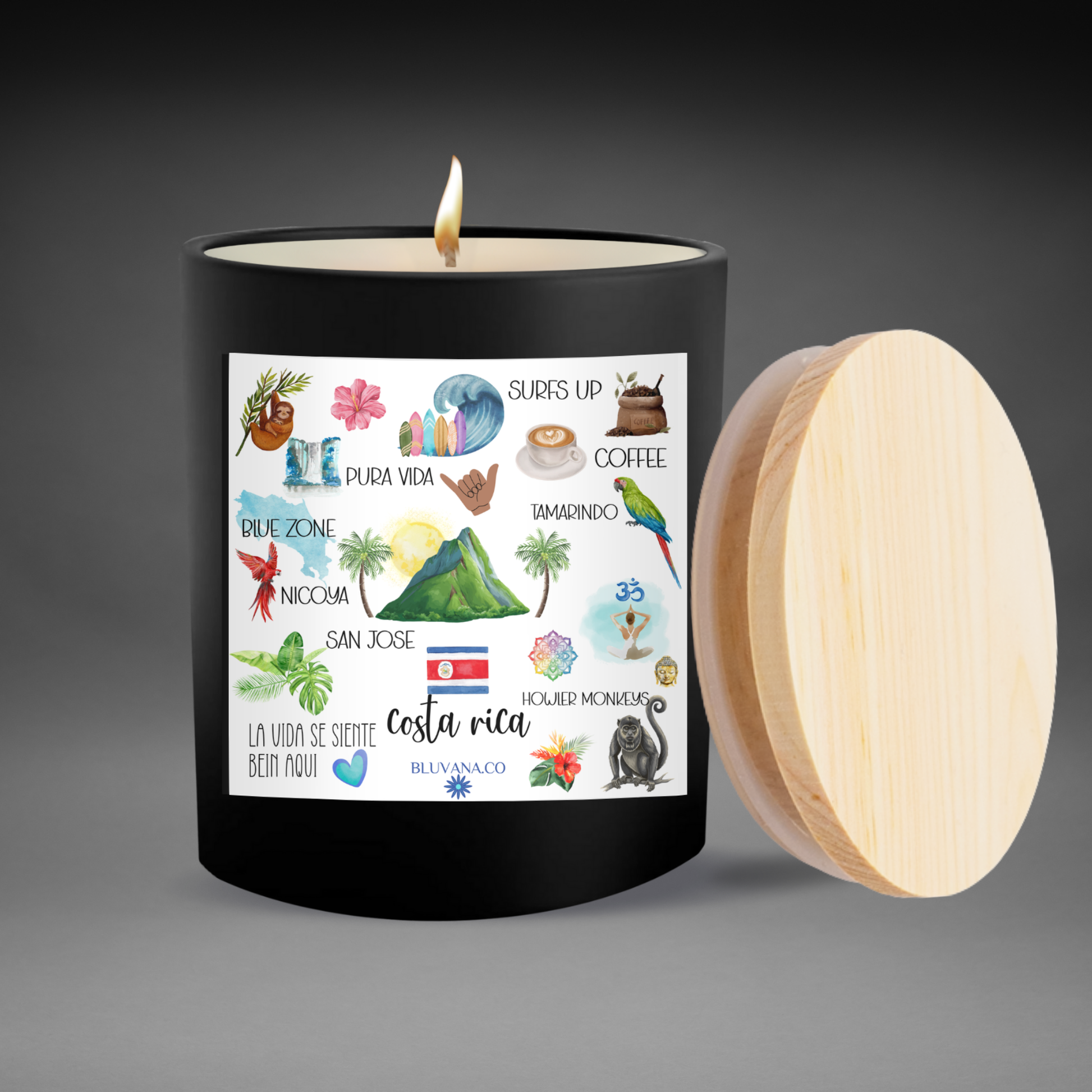 Black candle with a colorful label featuring illustrations and text, on a dark background.