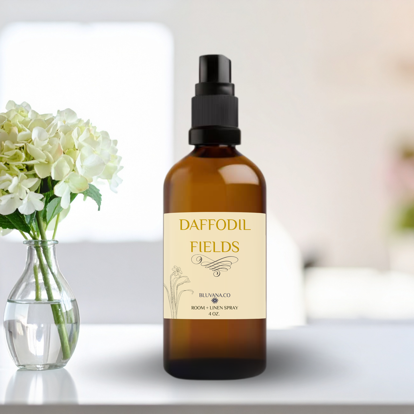Bottle of Daffodil Fields room and linen spray on a table with flowers in the background