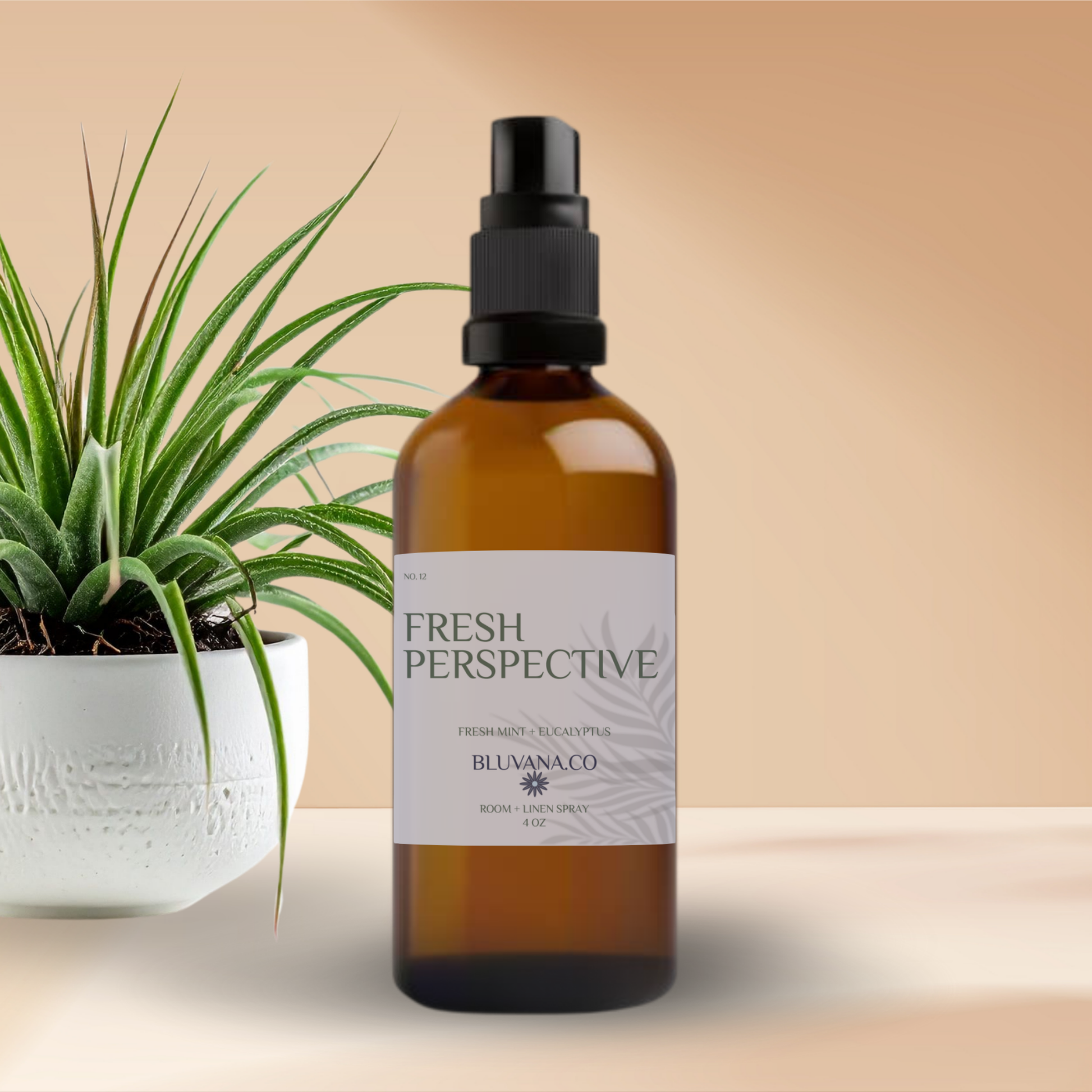Brown spray bottle labeled 'Fresh Perspective' with a plant on a beige background