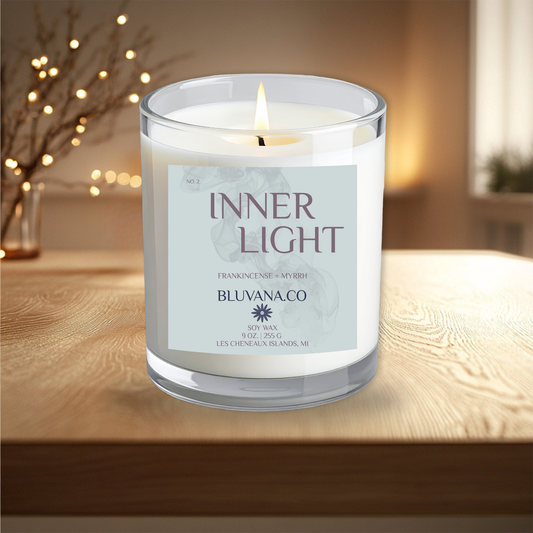 Candle labeled 'Inner Light' by Bluvanaco on a wooden surface with a blurred background