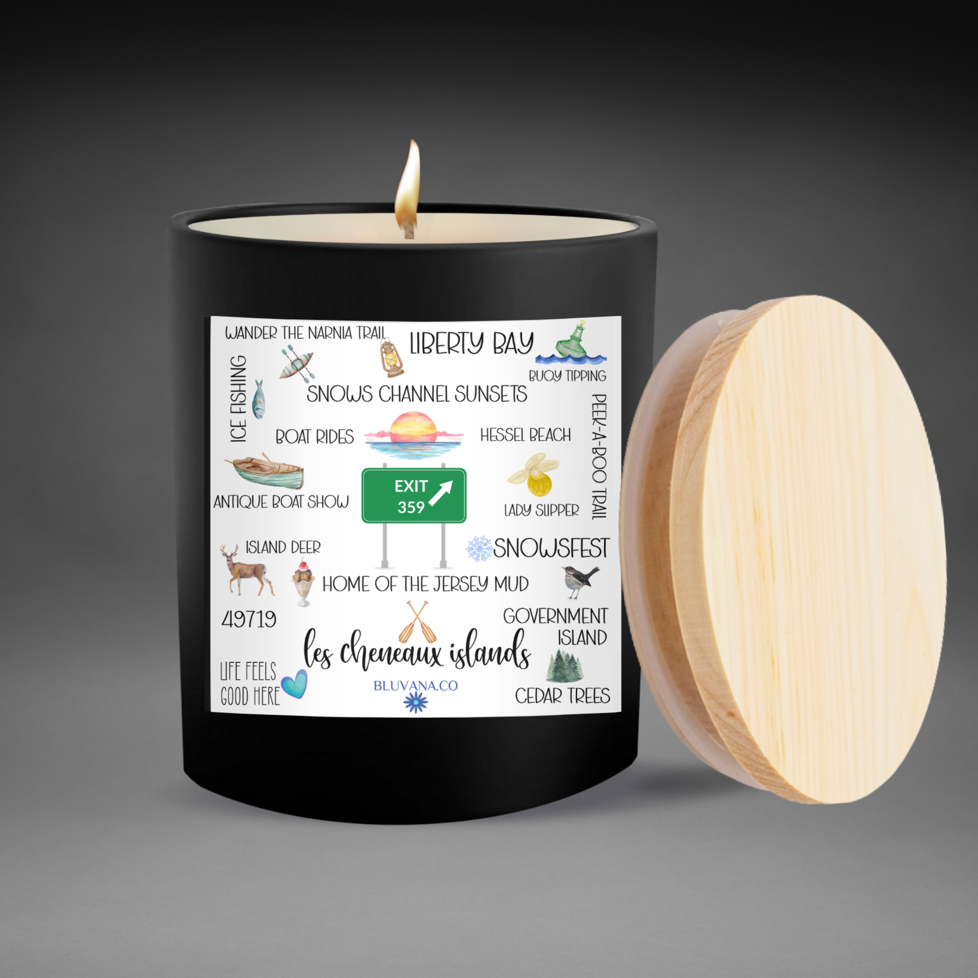 Les Cheneaux Islands Candle with a label on a gray background