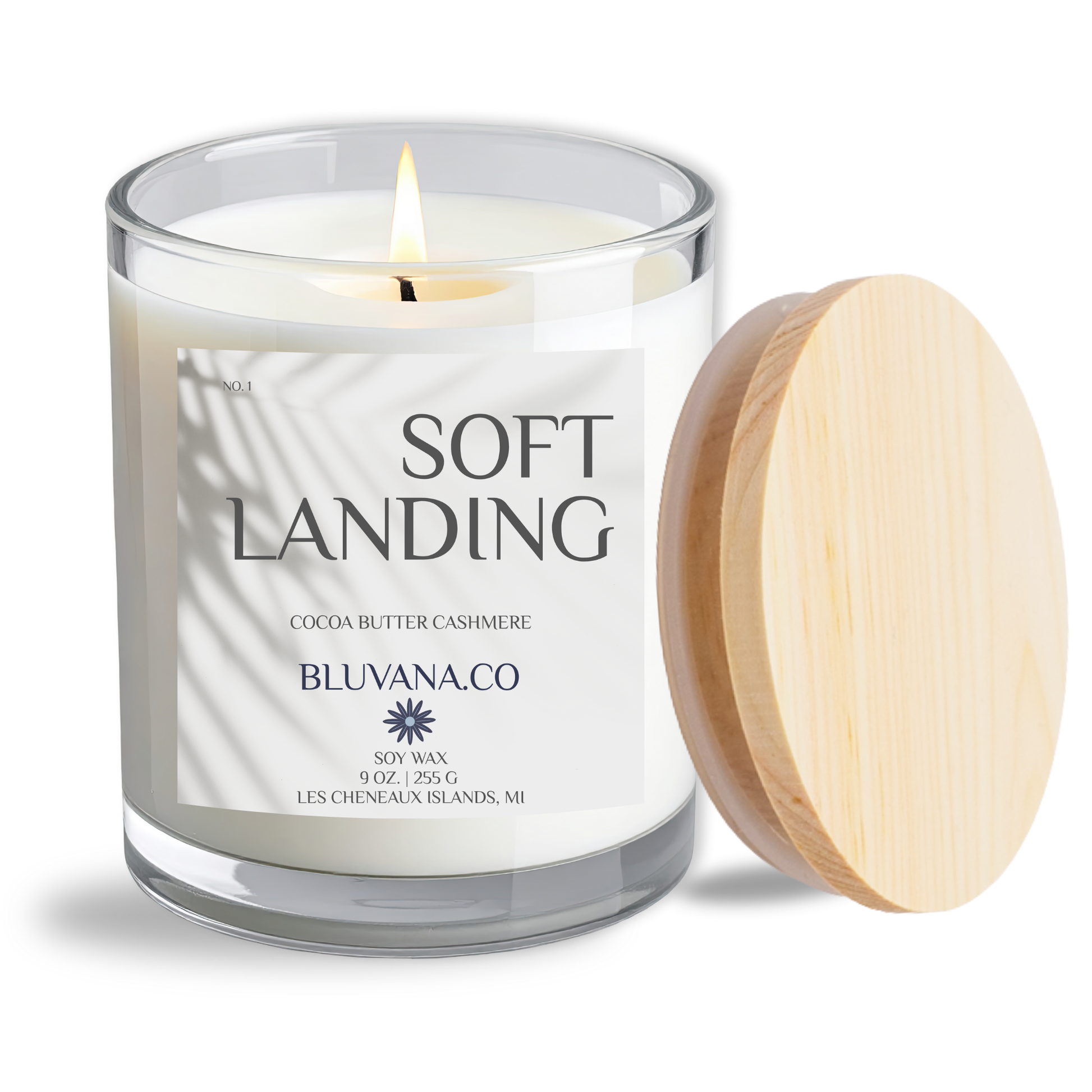 Candle with a wooden lid labeled 'Soft Landing' by Bluvana & Co on a white background