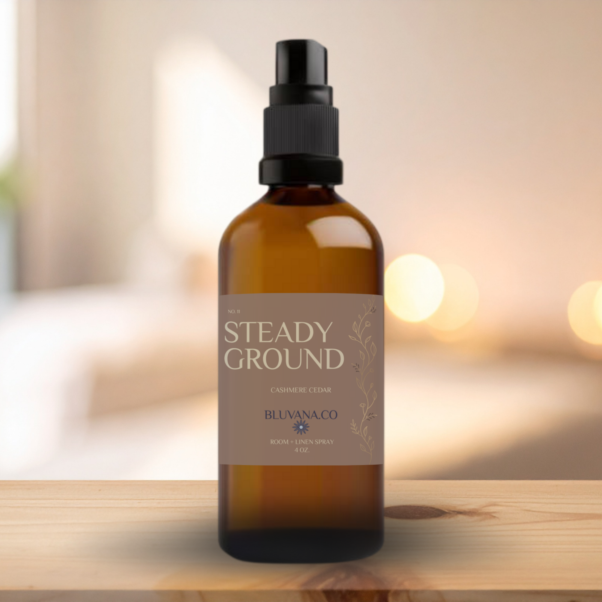 Brown spray bottle labeled 'Steady Ground' on a wooden surface with a blurred background