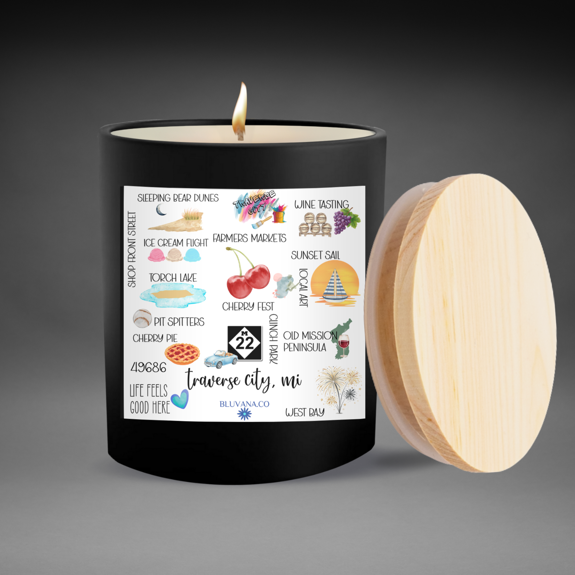 Candle with a label featuring Traverse City illustrations and text on a gray background
