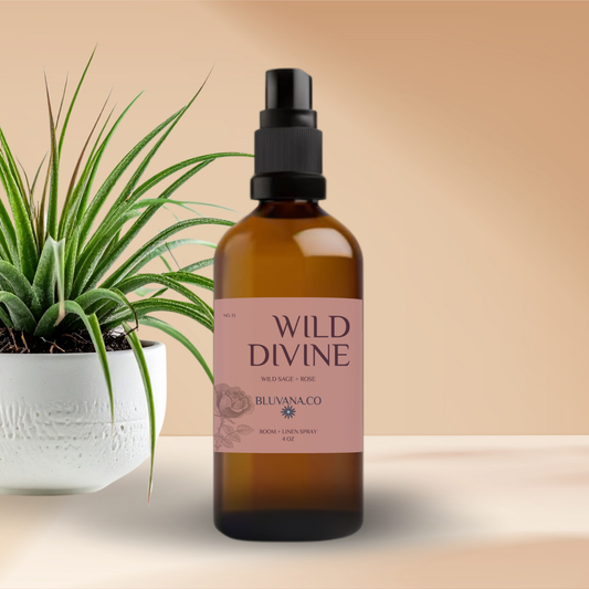 Brown bottle with 'Wild Divine' label next to a plant on a beige background