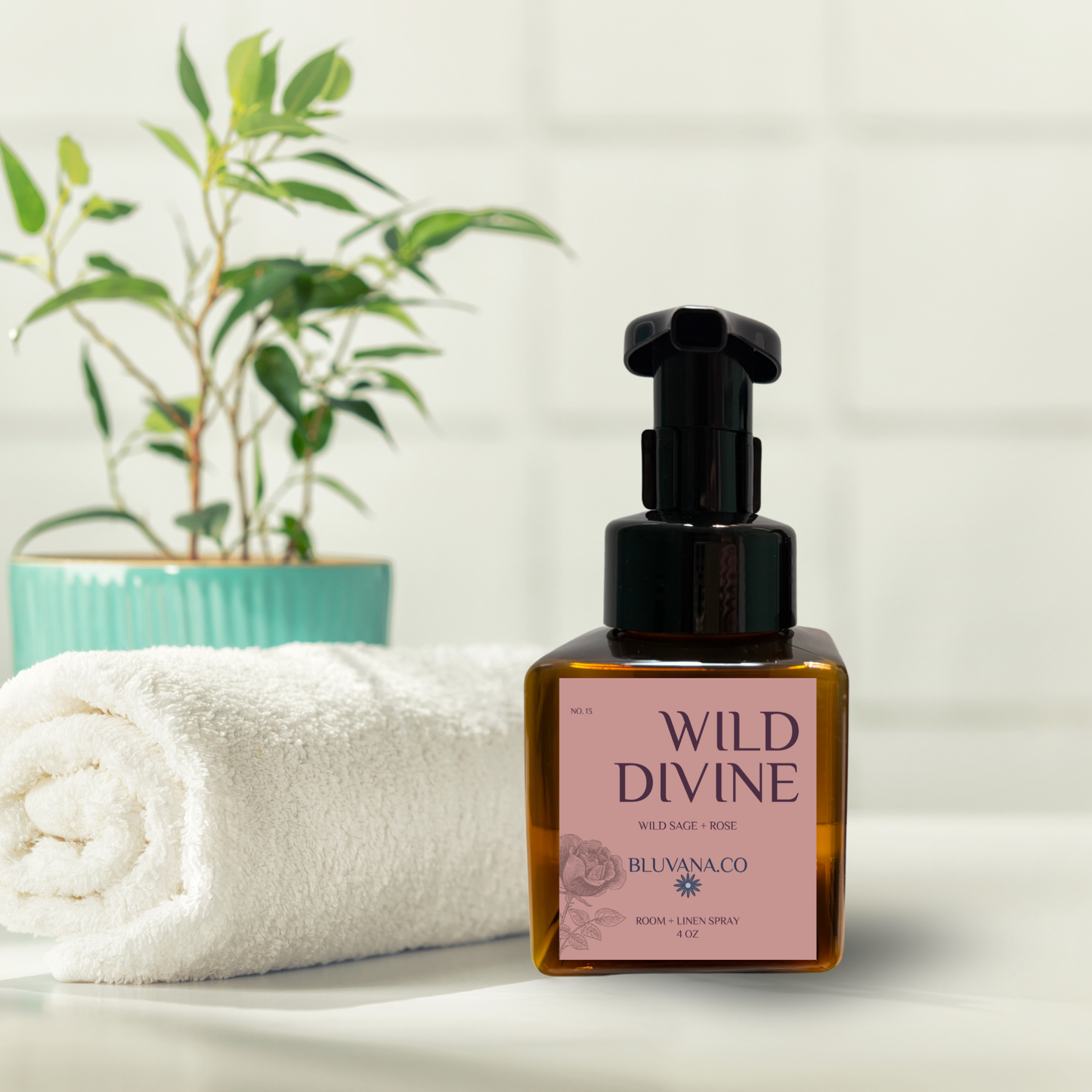 Bottle of 'Wild Divine' product by Bluvana Co on a white surface with a towel and plant in the background.